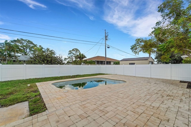 view of swimming pool with a fenced backyard, a fenced in pool, and a patio