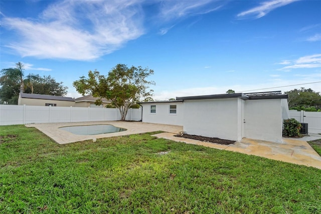 exterior space with stucco siding, a fenced backyard, a patio, and a yard