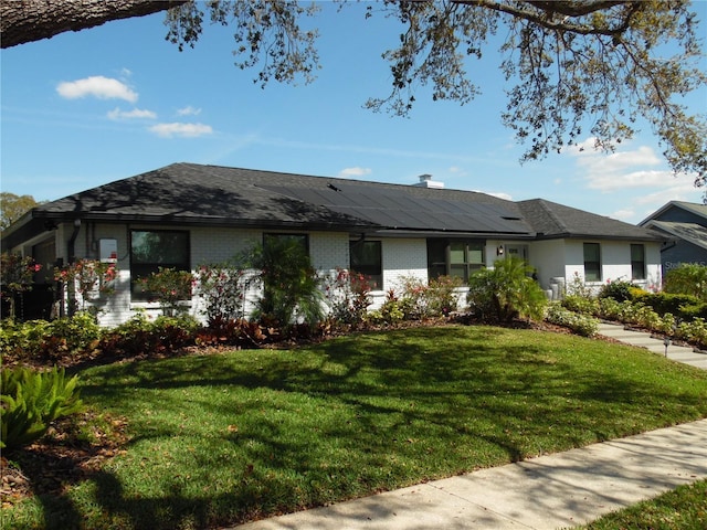 2709 Fairway View Dr, Valrico, FL 33596 - ranch-style house with a front yard, brick siding, and solar panels