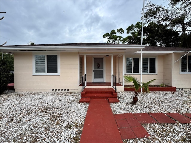 view of front of home featuring a porch, crawl space, and a shingled roof