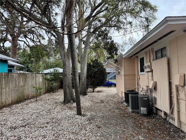 view of yard with fence and cooling unit