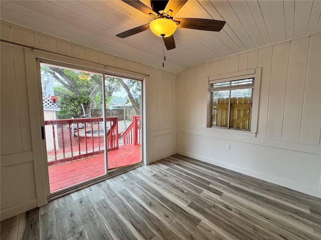 spare room with ceiling fan, wooden ceiling, and wood finished floors