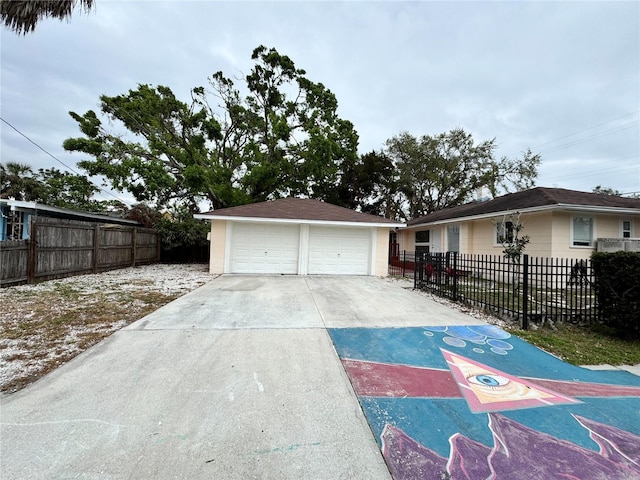 detached garage featuring fence