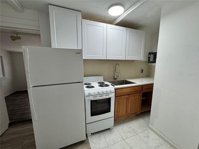 kitchen featuring white appliances, a sink, marble finish floor, light countertops, and backsplash