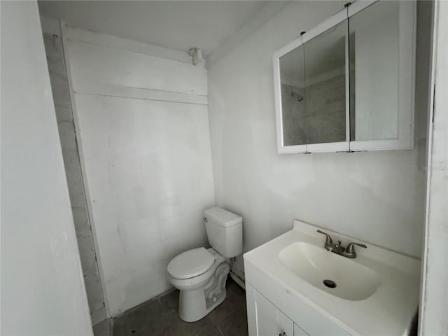 bathroom featuring vanity, tile patterned flooring, and toilet