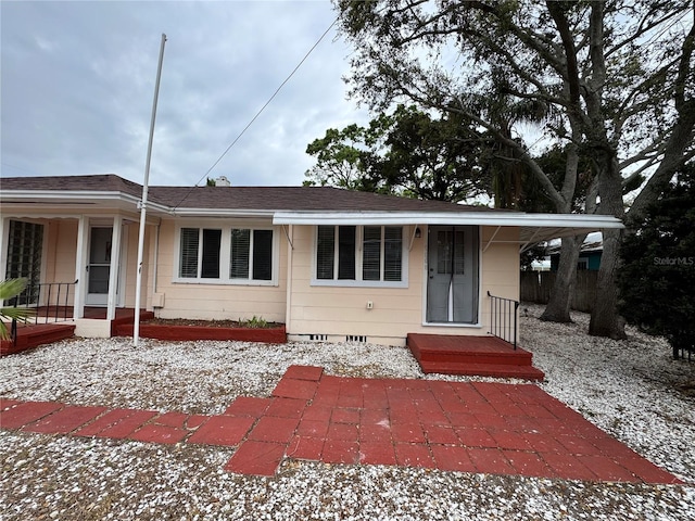 single story home with covered porch, a shingled roof, crawl space, and an attached carport