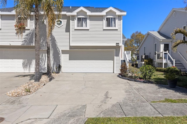 view of front of property featuring concrete driveway and an attached garage