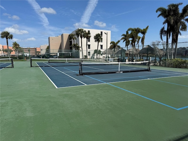 view of tennis court with fence