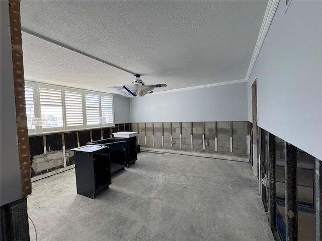 home office with a textured ceiling, ceiling fan, ornamental molding, and unfinished concrete flooring