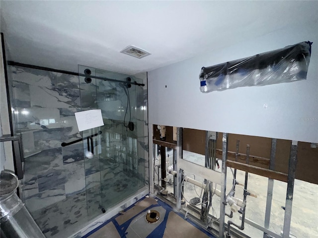 bathroom featuring a marble finish shower and visible vents