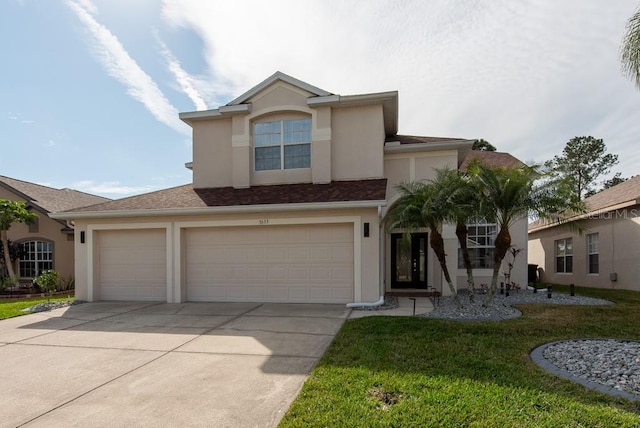 traditional home featuring driveway, a front yard, and stucco siding