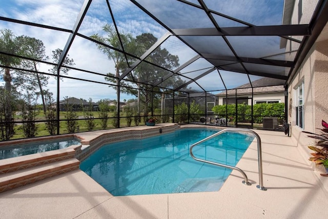 view of swimming pool with a pool with connected hot tub, glass enclosure, and a patio