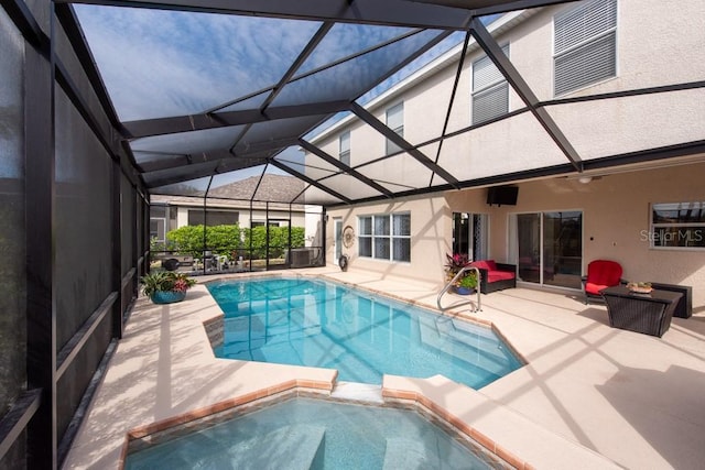 view of swimming pool with a pool with connected hot tub, a lanai, and a patio