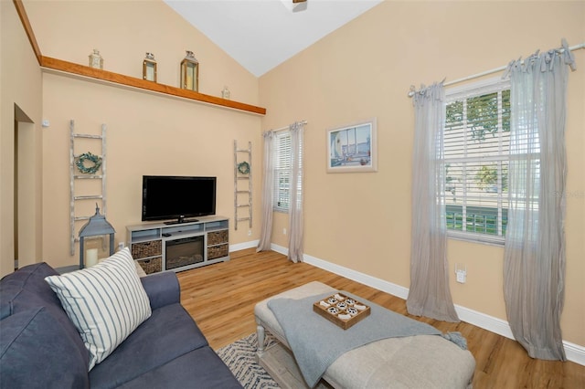 living room featuring a wealth of natural light, baseboards, and light wood-style floors