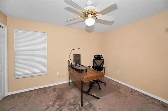 carpeted office featuring ceiling fan, a textured ceiling, and baseboards