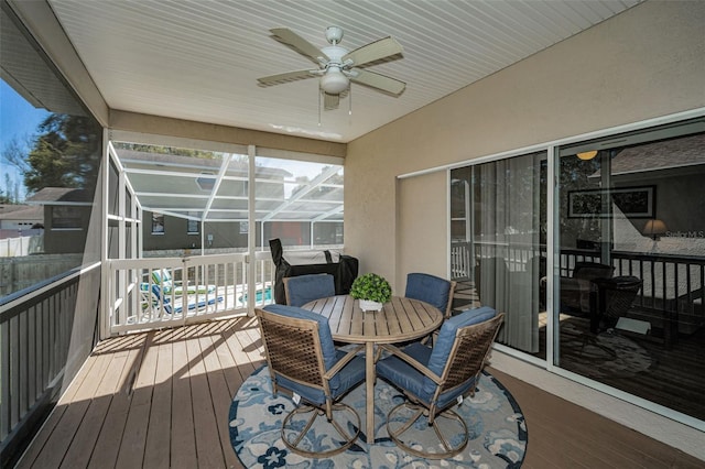 deck featuring a lanai, outdoor dining area, and ceiling fan