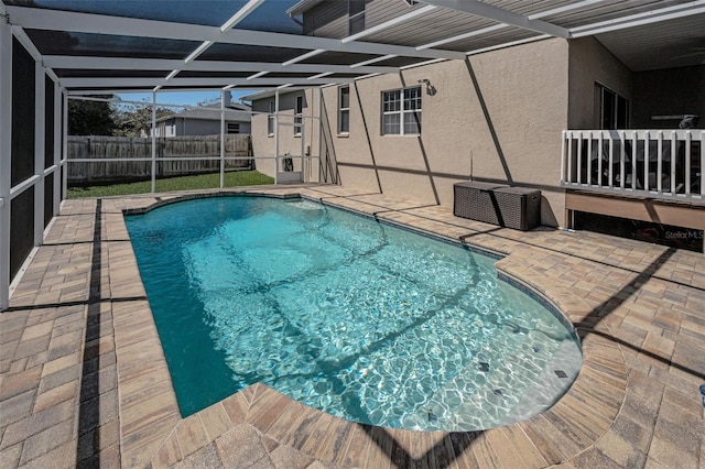 view of pool featuring a patio, a fenced backyard, a fenced in pool, and a lanai