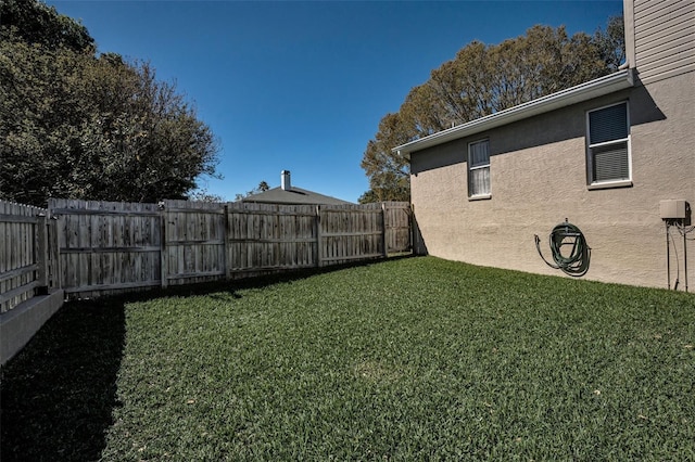 view of yard with a fenced backyard