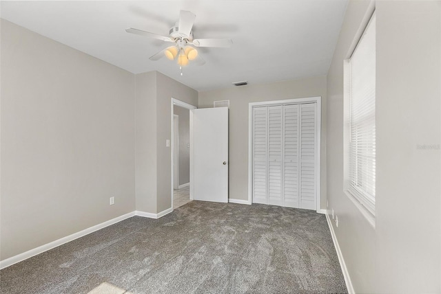 unfurnished bedroom with a closet, visible vents, baseboards, and carpet flooring