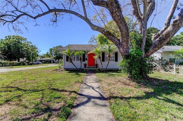 view of front of property with a front lawn and fence