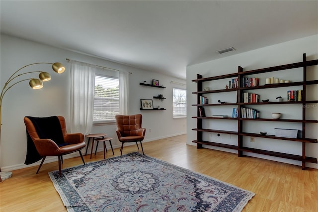 sitting room featuring baseboards and wood finished floors