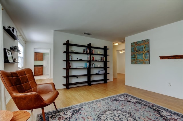 sitting room featuring wood finished floors and visible vents