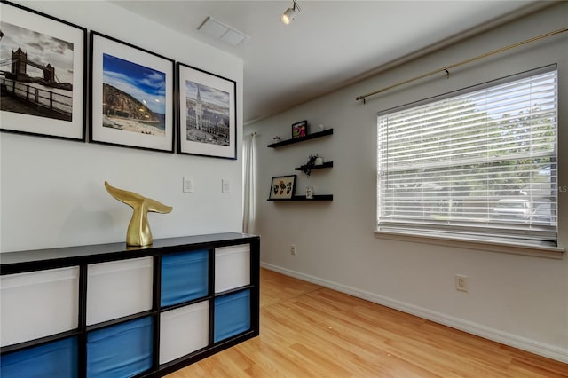 interior space with visible vents, light wood-type flooring, and baseboards