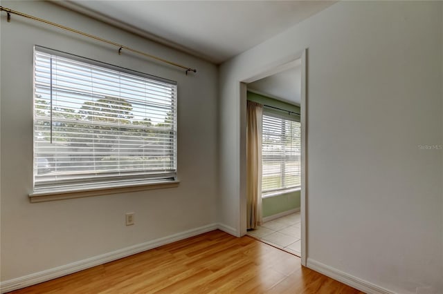 empty room featuring light wood-style floors and baseboards