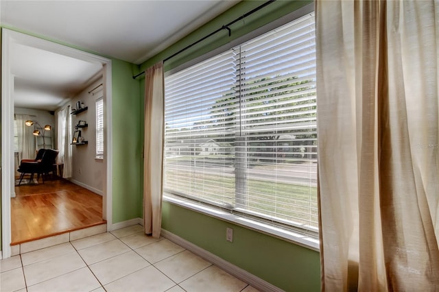 hall with light tile patterned floors and baseboards