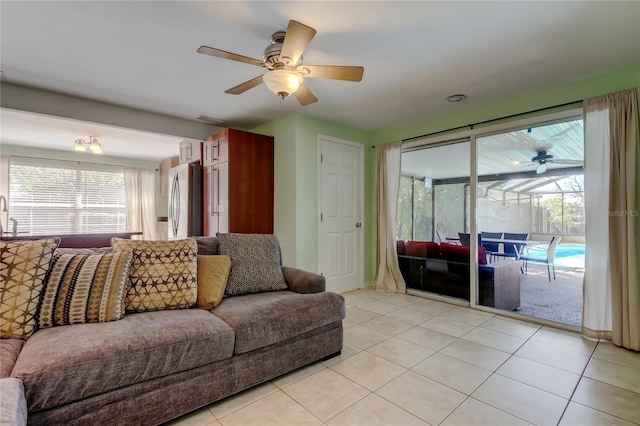 living room featuring light tile patterned floors and a ceiling fan