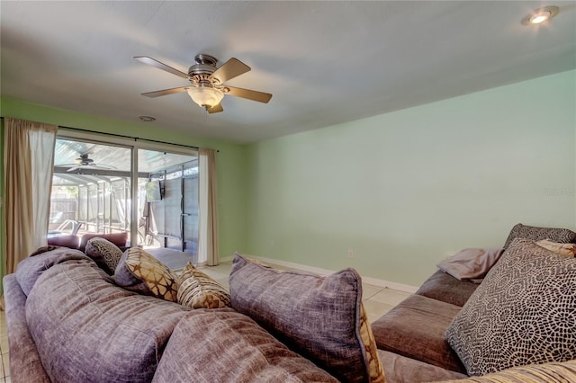 living area featuring light tile patterned flooring, baseboards, and ceiling fan