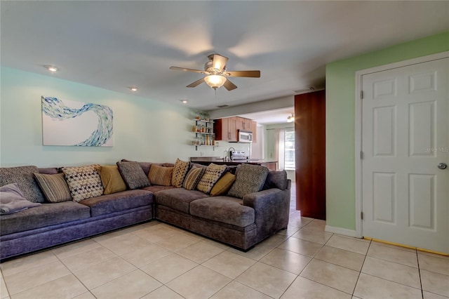 living room featuring light tile patterned floors, visible vents, and a ceiling fan