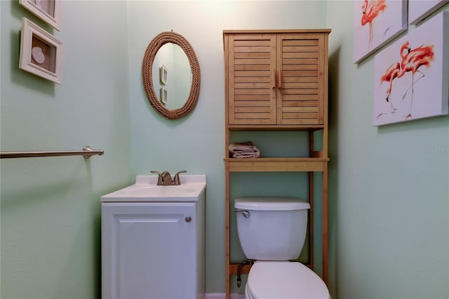 half bath featuring toilet and vanity