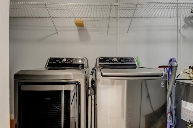 clothes washing area featuring washing machine and clothes dryer and laundry area