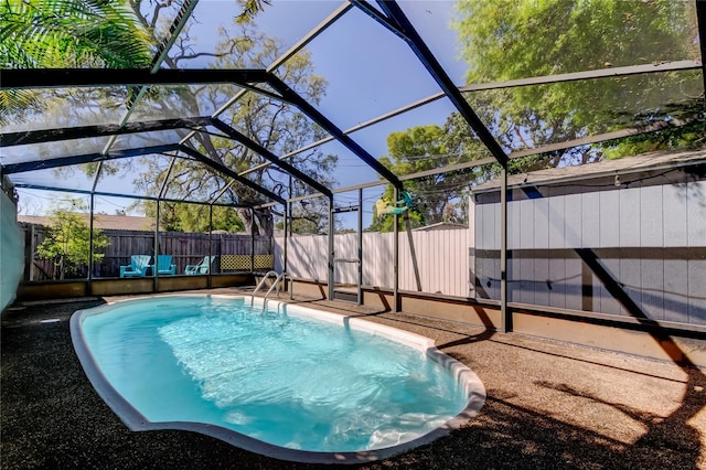 view of swimming pool with a lanai, a fenced in pool, and a fenced backyard