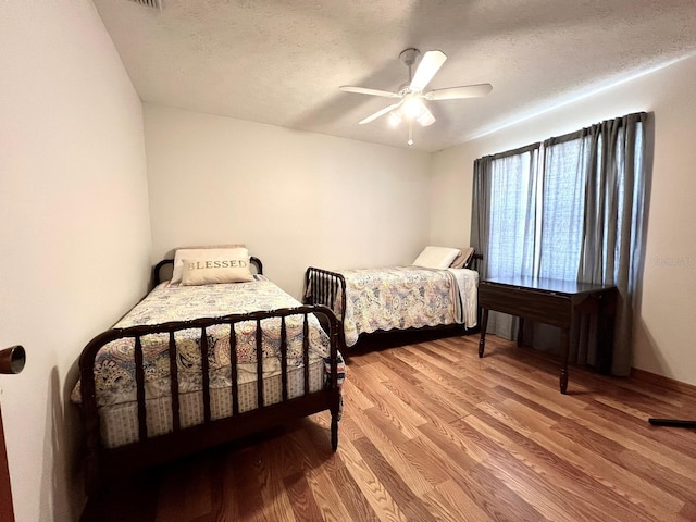 1811 Tawnee Pl, Brandon, FL 33510 - bedroom with a textured ceiling, ceiling fan, and light wood-style floors