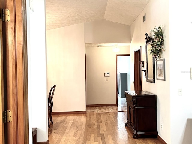 1811 Tawnee Pl, Brandon, FL 33510 - corridor with visible vents, light wood finished floors, a textured ceiling, and lofted ceiling