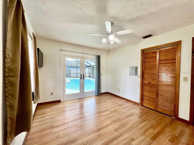 1811 Tawnee Pl, Brandon, FL 33510 - unfurnished bedroom with light wood-style floors, visible vents, access to exterior, and a textured ceiling