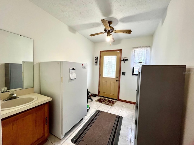 1811 Tawnee Pl, Brandon, FL 33510 - doorway with light tile patterned floors, ceiling fan, a textured ceiling, and a sink