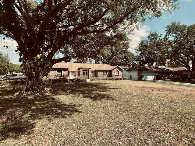 1811 Tawnee Pl, Brandon, FL 33510 - ranch-style home with a front yard and an attached garage