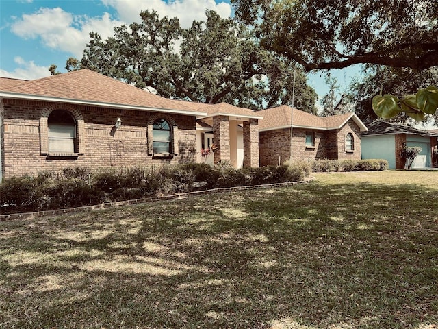 1811 Tawnee Pl, Brandon, FL 33510 - ranch-style house with a front yard, a shingled roof, and brick siding