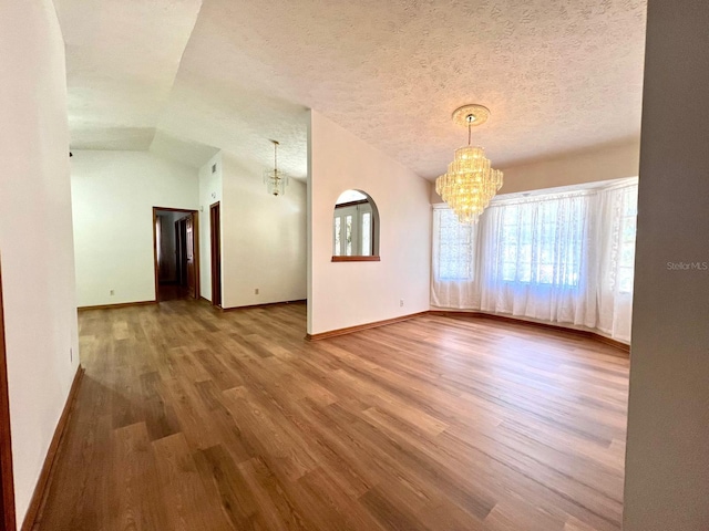 1811 Tawnee Pl, Brandon, FL 33510 - interior space with a textured ceiling, a notable chandelier, wood finished floors, and baseboards