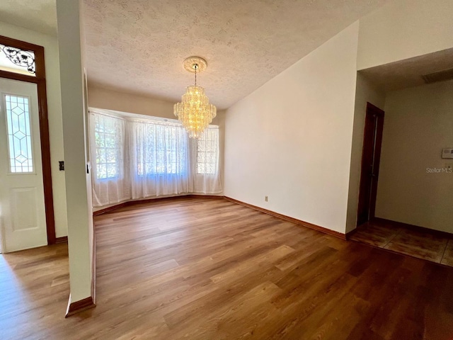 1811 Tawnee Pl, Brandon, FL 33510 - entrance foyer with baseboards, wood finished floors, an inviting chandelier, and a textured ceiling