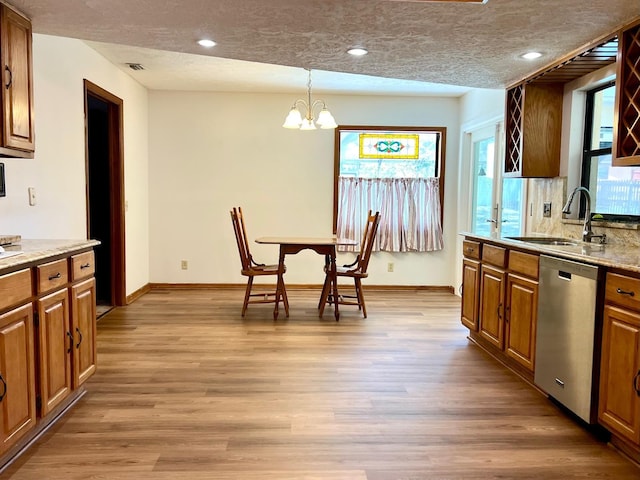 1811 Tawnee Pl, Brandon, FL 33510 - kitchen with stainless steel dishwasher, a sink, an inviting chandelier, light wood-type flooring, and recessed lighting