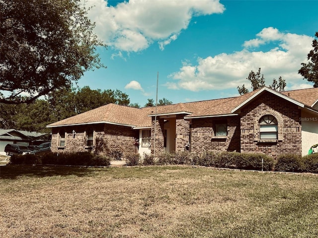 1811 Tawnee Pl, Brandon, FL 33510 - ranch-style house with a shingled roof, brick siding, and a front lawn