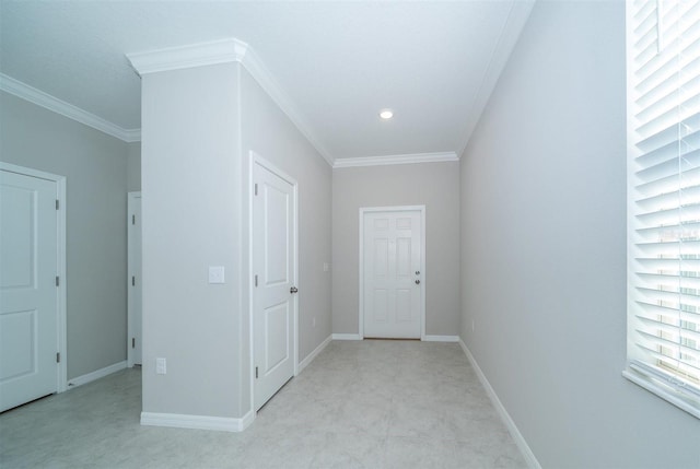 interior space with baseboards and crown molding