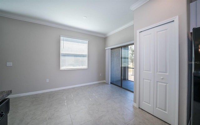 unfurnished room featuring ornamental molding and baseboards