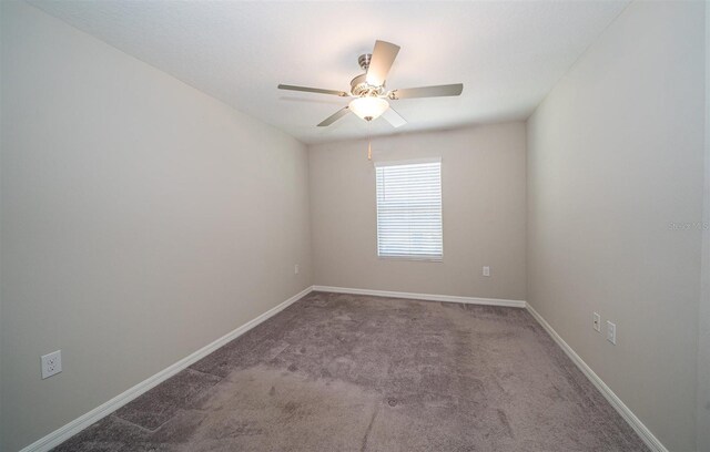 empty room with carpet, ceiling fan, and baseboards