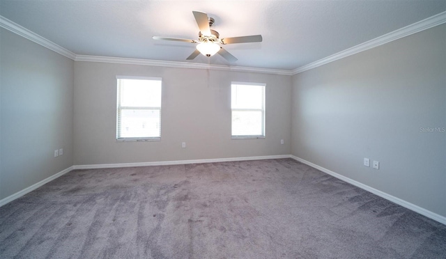 carpeted empty room featuring ceiling fan, ornamental molding, a wealth of natural light, and baseboards