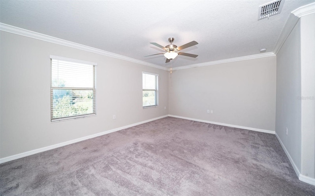 carpeted empty room with visible vents, ornamental molding, ceiling fan, a textured ceiling, and baseboards